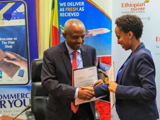 CEO of Ethiopost, Hanna Arayaselassie (R), and Ethiopian Airlines Group CEO, Mesfin Tasew (L)