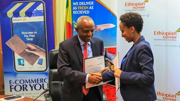 CEO of Ethiopost, Hanna Arayaselassie (R), and Ethiopian Airlines Group CEO, Mesfin Tasew (L)